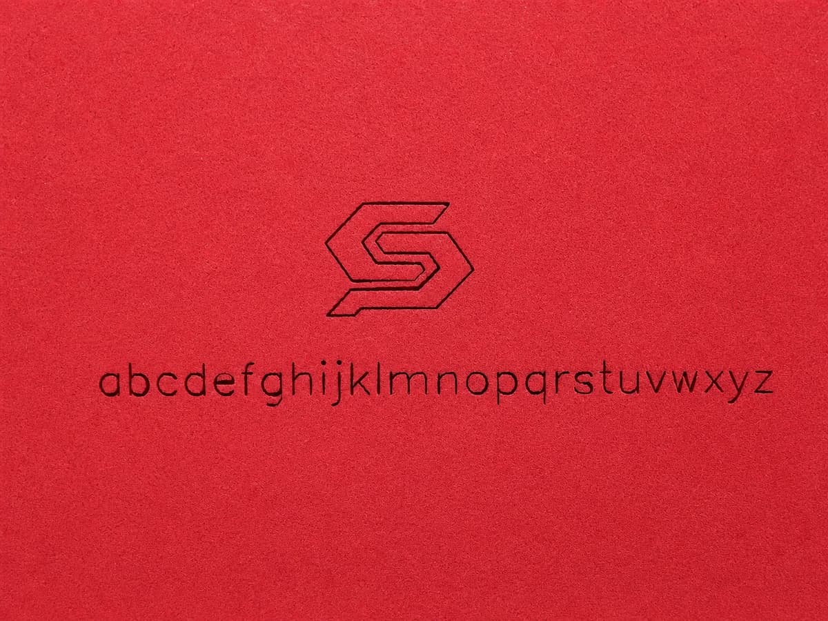 Laser-engraved logo and lowercase alphabet on red foam