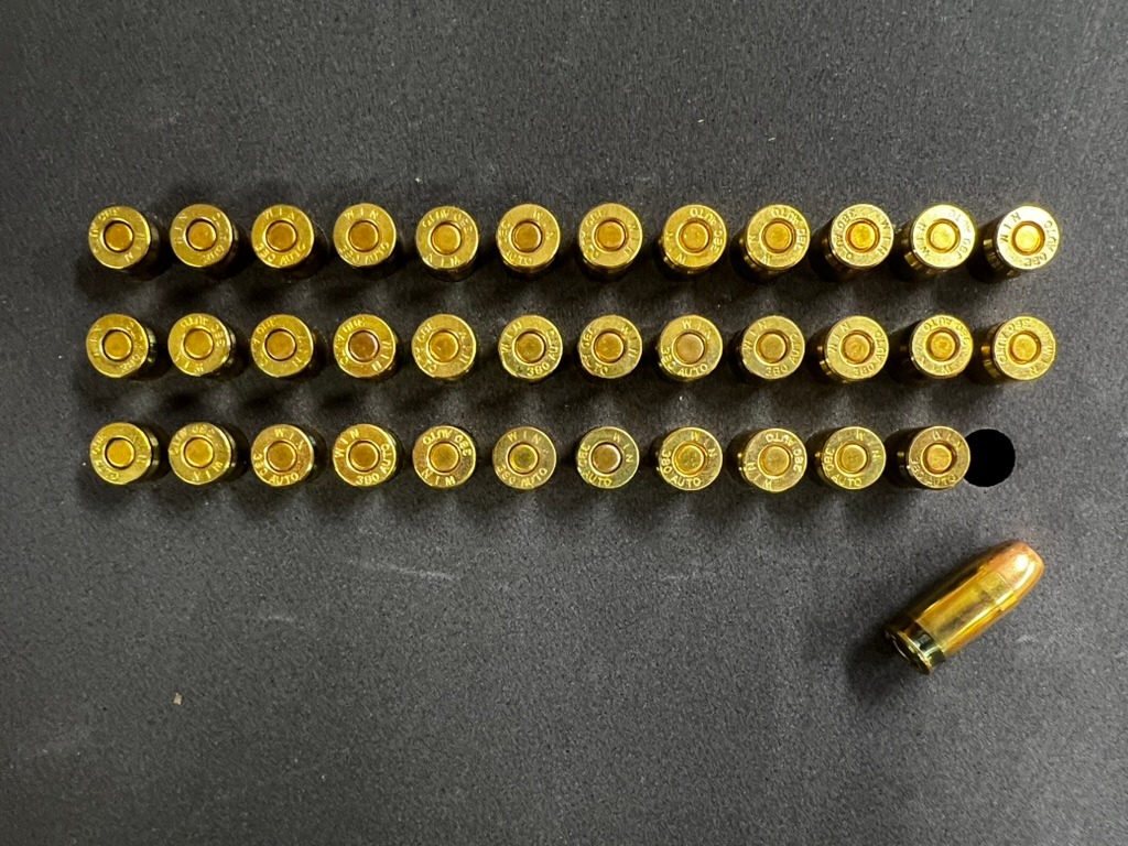 Three rows of cartridge cases arranged in a foam pocket grid