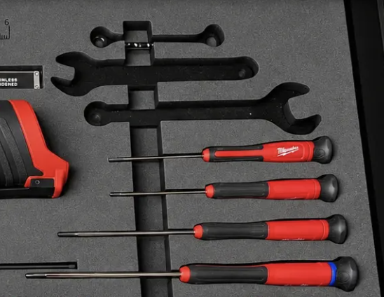 Several small tools arranged beside one shared finger pull opening in a foam insert